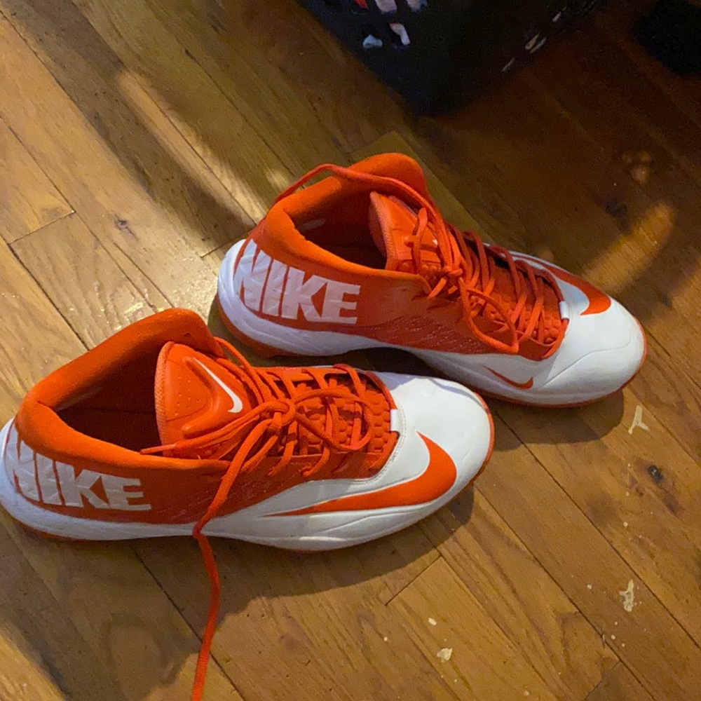 Men’s size 15 white and orange cleats